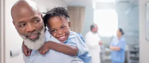 father-giving-piggyback-to-son-in-hospital