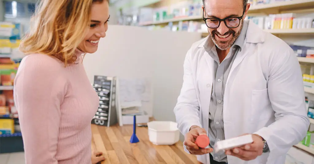 pharmacist-suggesting-medical-drug-to-buyer