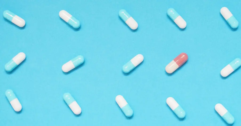 brown-capsule-among-many-blue-and-white-capsule-pills-for-rare-diseases