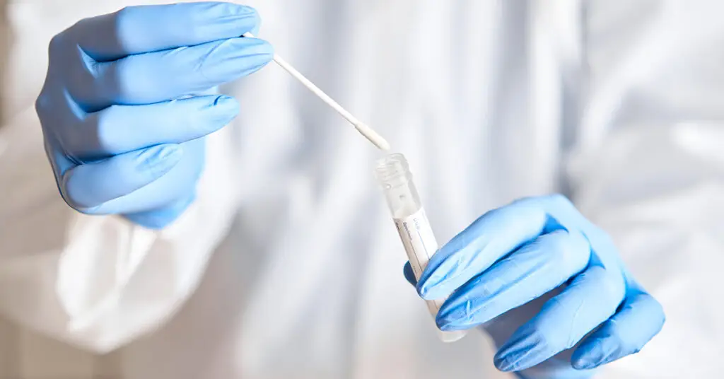 doctor-holding-swab-test-tube-genetic-testing
