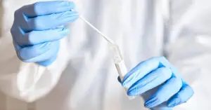doctor-holding-swab-test-tube-genetic-testing