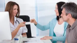 patients-using-health-insurance-card-at-doctors-office